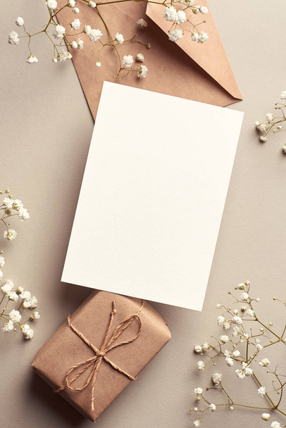 Invitation or greeting card mockup with gift box and gypsophila plant twigs - Foto, Imagen