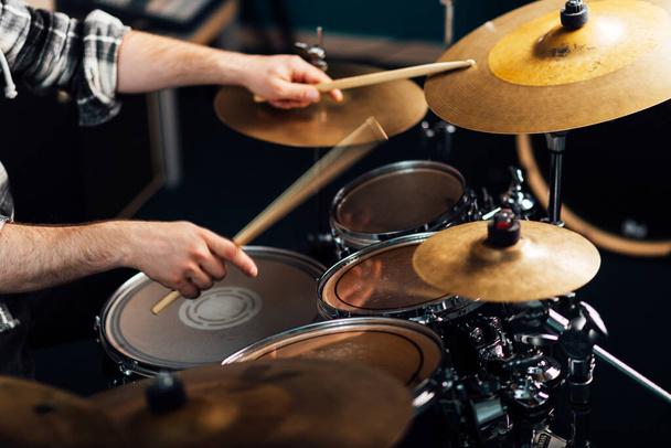 Drummer banging on a cymbal in a drum set. - 写真・画像
