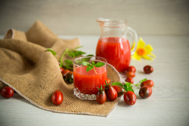 homemade freshly squeezed tomato juice with pulp in a glass decanter - Фото, изображение
