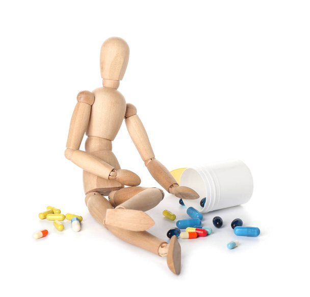 Wooden mannequin with pills on white background - Photo, Image