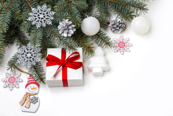 Christmas decorations and a gift in a box lying on a white background. Copy space. - Foto, immagini