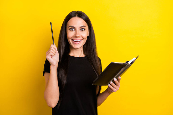 Photo of pretty amazed lady arm hold notebook pencil unbelievable isolated on yellow color background - Фото, изображение