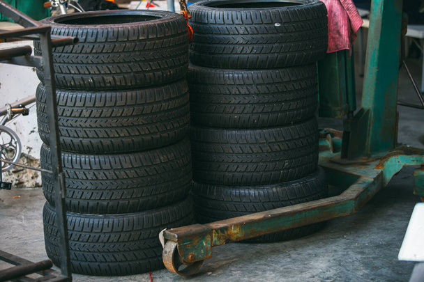 Group of new tires for race car. New tires for sale at a tire store. Car tires in the warehouse. - Foto, Imagem