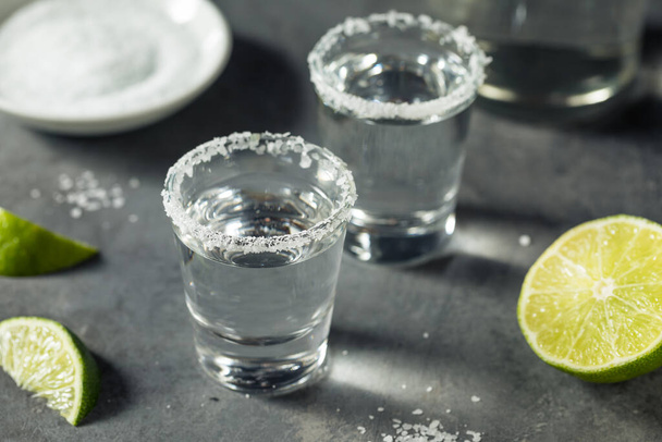 Boozy Cold Tequila Shots with Lime and Salt - Valokuva, kuva