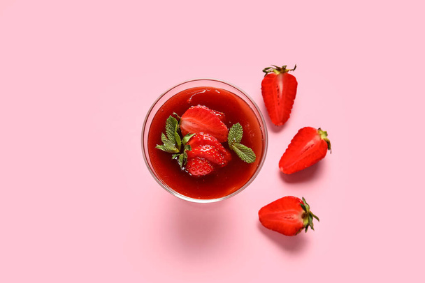 Glass with tasty strawberry panna cotta on pink background - Photo, Image