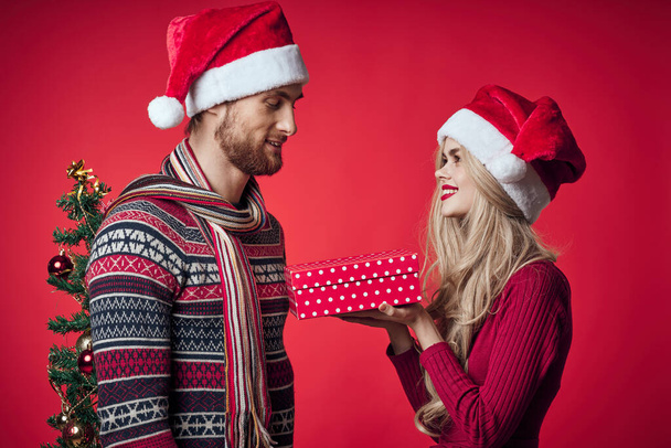 man and woman christmas holiday romance red background - Photo, Image