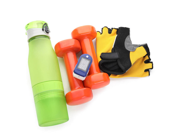 Set of sports items and pulse oximeter on white background - Photo, Image