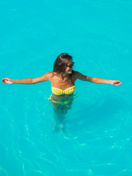 A girl is relaxing in a swimming pool - Photo, image