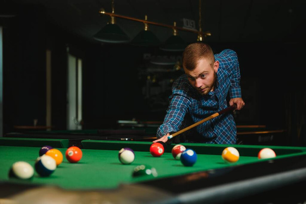 Man playing billiards in a club - Photo, Image