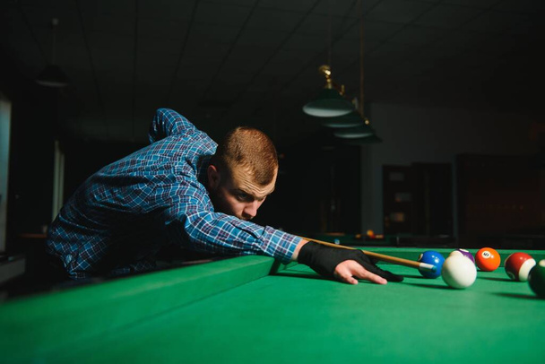 Man playing billiards in a club - Zdjęcie, obraz