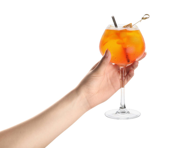 Female hand with glass of Aperol spritz cocktail on white background - Фото, изображение