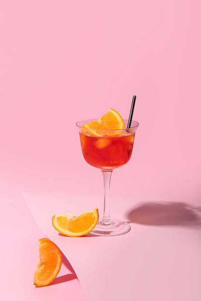 Glass of Aperol spritz cocktail on color background - Fotoğraf, Görsel