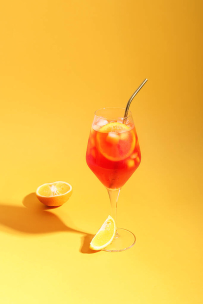 Glass of Aperol spritz cocktail on color background - Фото, зображення