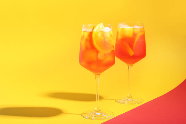 Glasses of Aperol spritz cocktail on color background - Photo, Image