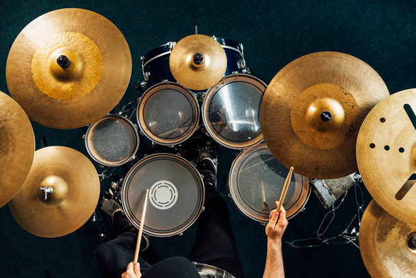 Drummer playing complete drum kit top view. - Фото, изображение