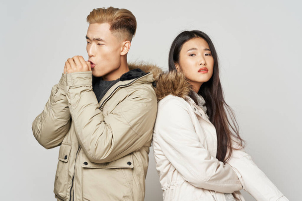young couple asian appearance winter jackets fashion - Фото, зображення