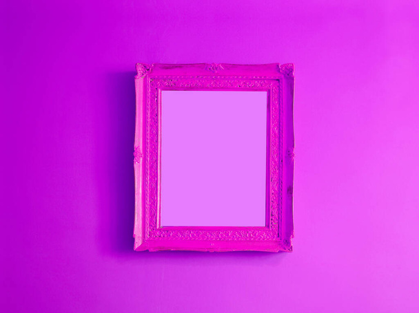 Hot pink antique empty photo frame isolated on gradient purple colored wall - Foto, Imagem
