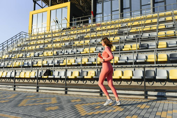 Fitness woman on city stadium - 写真・画像