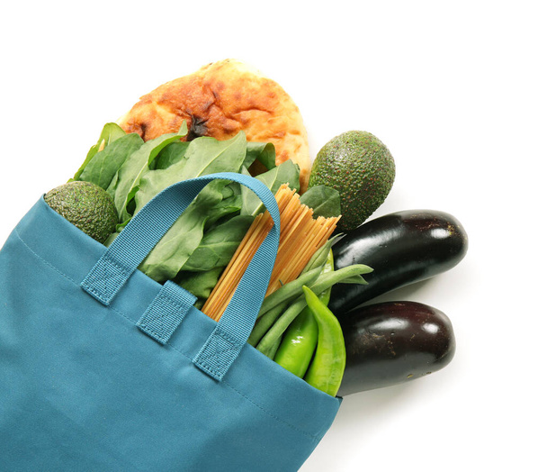 Eco bag with grocery on white background - Foto, afbeelding