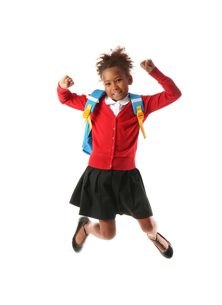 Jumping African-American schoolgirl on white background - Valokuva, kuva