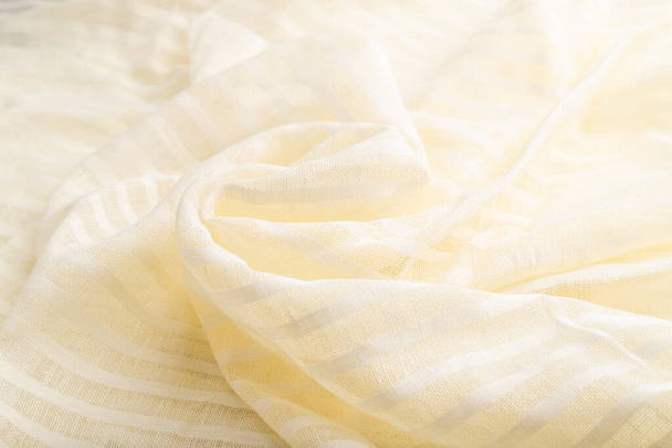 Fragment of white linen tissue. Side view, natural textile background and texture. wave concept, abstract, spiral form. - Photo, Image