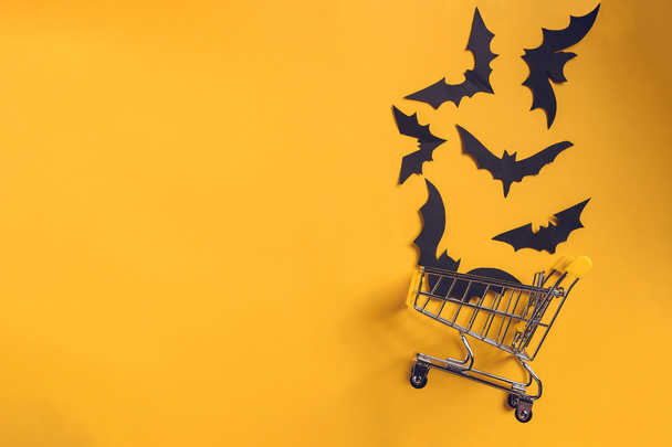 Festive halloween background with paper bats on a shopping trolley.Mock up flatly for party or sale. Top view.Copy Space - Fotografie, Obrázek