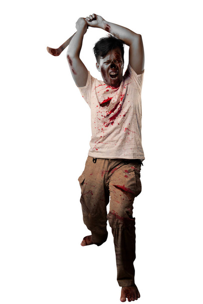 Scary zombie with blood and wound on his body holding sickle standing isolated over white background - 写真・画像