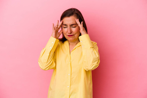 Middle age caucasian woman isolated on pink background touching temples and having headache. - Photo, Image