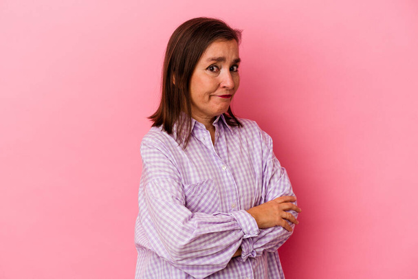 Middle age caucasian woman isolated on pink background unhappy looking in camera with sarcastic expression. - Photo, Image