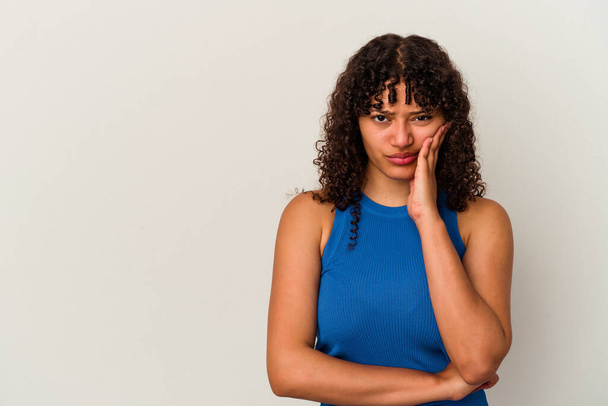 Young mixed race woman isolated on white background who feels sad and pensive, looking at copy space. - Foto, imagen