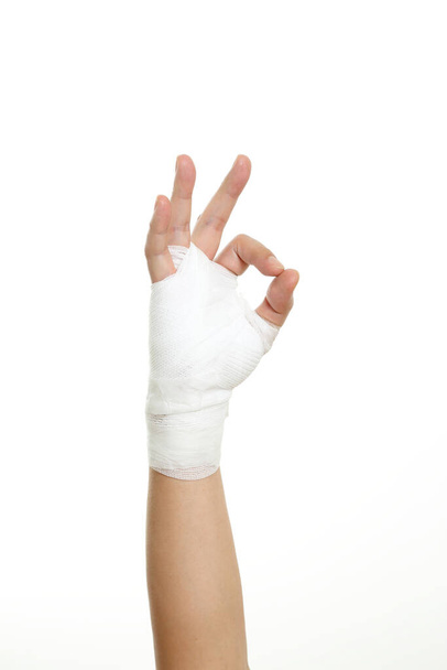 Human's hand with bandage on the white background. - Foto, Imagen