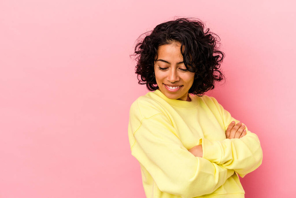 Young curly latin woman isolated on pink background smiling confident with crossed arms. - Fotografie, Obrázek
