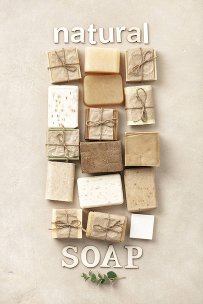 Flat lay composition with handmade soap bars and wood letters on beige background - Foto, Imagen