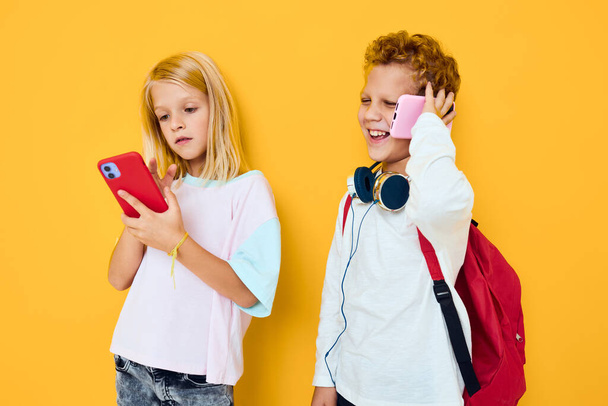 teenage boy and girl use gadgets with headphones Studio education concept - Fotó, kép