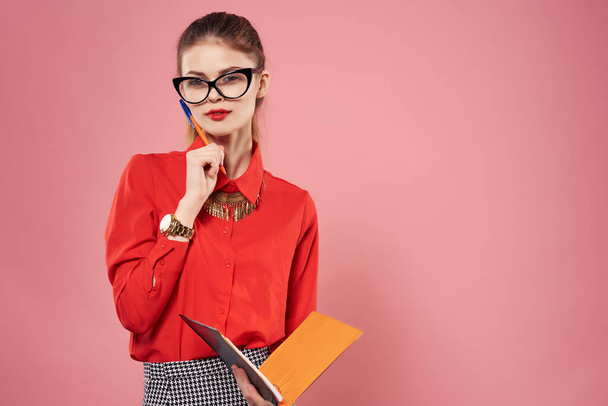 Business woman with glasses in red shirt secretary professional pink background - Fotografie, Obrázek