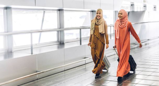 Two young beauty islamic asian arabic muslim woman wearing a hijab enjoying shopping and having fun talking together in the shop at fashion store - Φωτογραφία, εικόνα