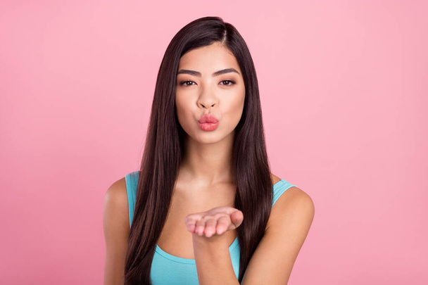Photo of romantic millennial brown hairdo lady blow kiss wear blue top isolated on pastel pink color background - Photo, Image