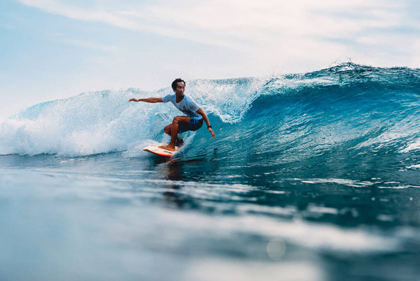 11 апреля 2019 года. Бали, Индонезия. Индонезийский серфер Алик Рудиарта тренируется на доске для серфинга на океанской волне.  - Фото, изображение