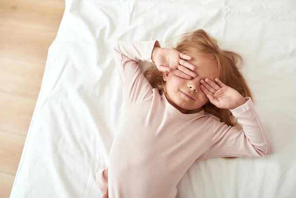 Small girl child wakeup in bed after sleep - Valokuva, kuva