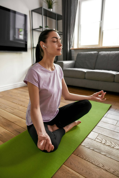 Vertical shot of woman meditate practice yoga - Фото, изображение