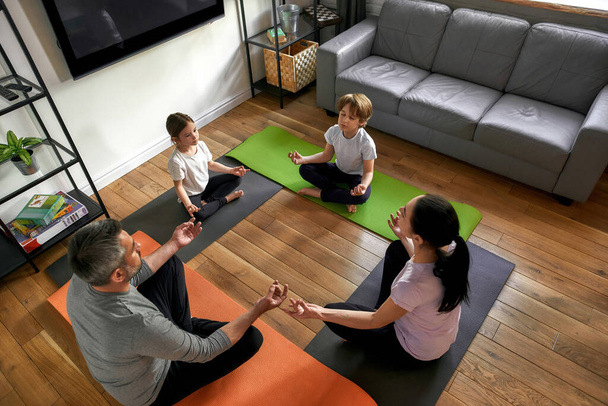 Top down of family with kids meditate at home - Photo, Image