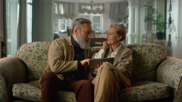 Retired man woman looking tablet screen. Hugged couple using digital device. - Fotografie, Obrázek