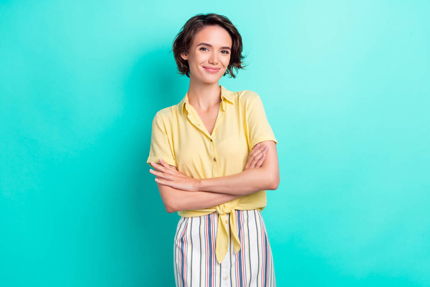 Photo of young attractive girl happy positive smile confident crossed hands isolated over turquoise color background - 写真・画像