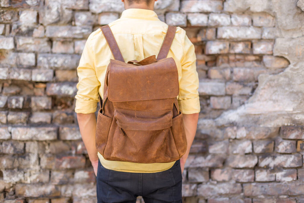 Back of man with brown leather backpack. Unisex bag for sale. Unbranded backpack. - Photo, Image