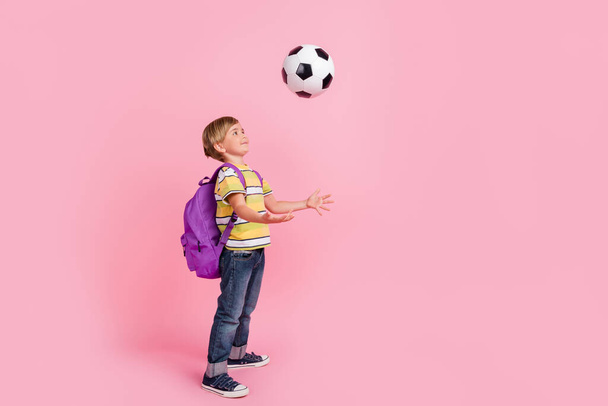 Full length photo of young small happy boy throw ball wear bag smile isolated on pink color background - Foto, immagini