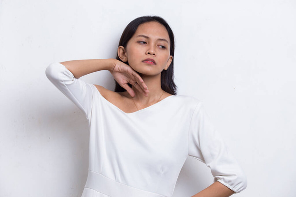 portrait of stressed sick asian beautiful woman with headache on white background - Zdjęcie, obraz