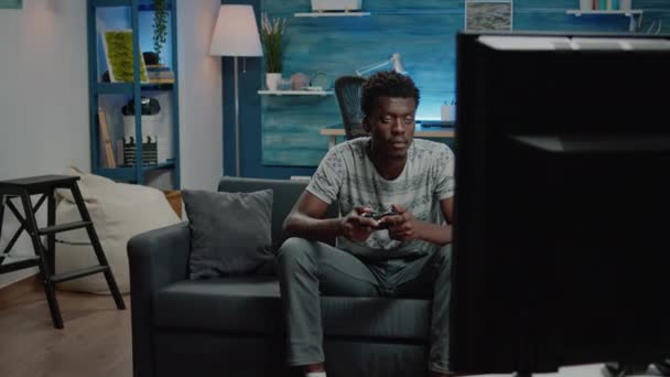 Man playing video games on tv console with controller - Footage, Video
