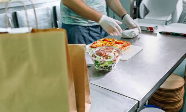 Unrecognizable cook packing takeaway orders - Photo, Image
