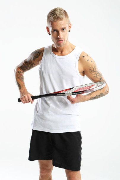 Handsome man with a squash racket - 写真・画像