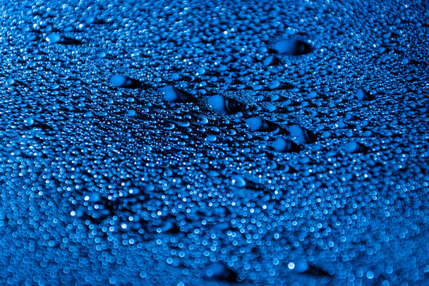 Colourful abstract background with water drops illuminated with blue LED light. - Photo, Image